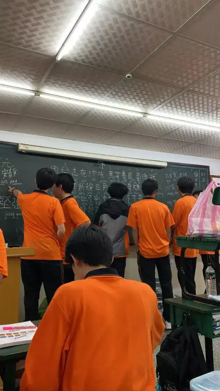 Classmates gathered by the classroom board